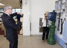 Michael Hesse of the Denver Police Museum takes a photo of Pat Nading-Amman beside an historical police call box at the Saskatoon police station during a tour for police historians, Tuesday, June 28, 2016.