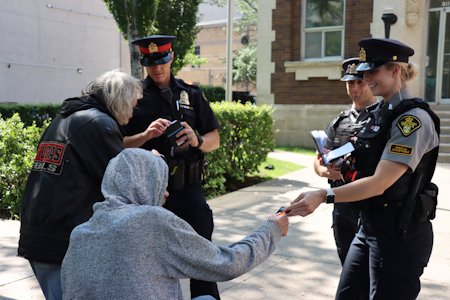 Officers in discussion with members of the public in the downtown area